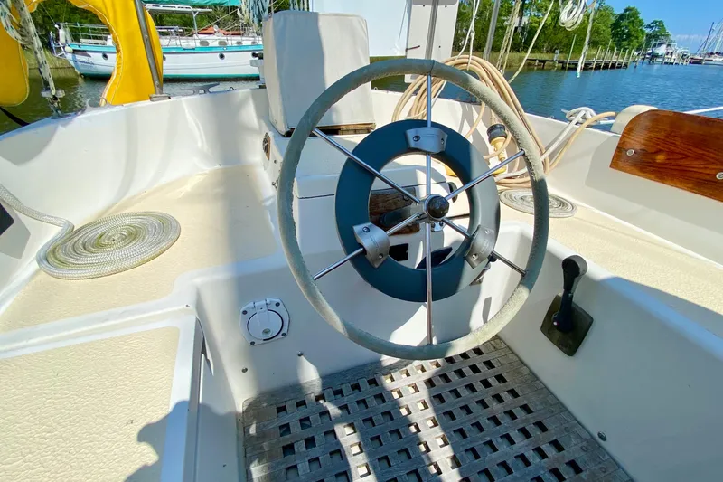 Slide: The Image of 1977 Allied Princess Cutter sailboat cockpit with steering wheel and nautical equipment. - 31