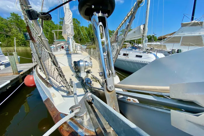 Slide: The Image of 1977 Allied Princess Cutter sailboat docked, showcasing deck and rigging details. - 5