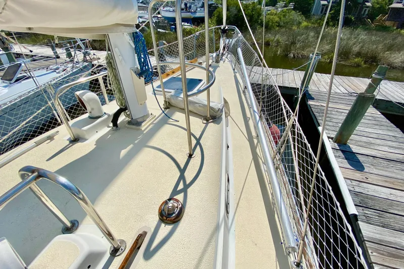 Slide: The Image of Deck view of a 1977 Allied Princess Cutter sailboat docked at a marina. - 6