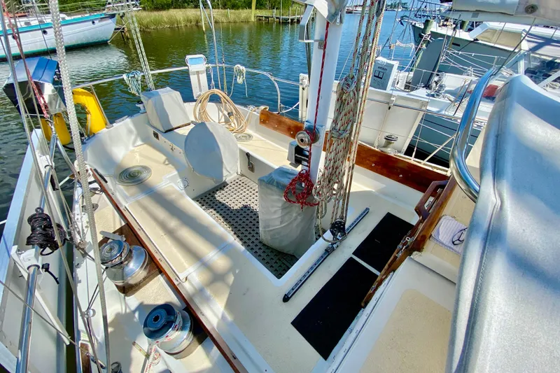 Slide: The Image of Cockpit of 1977 Allied Princess Cutter sailboat with ropes and winches, docked in marina. - 7