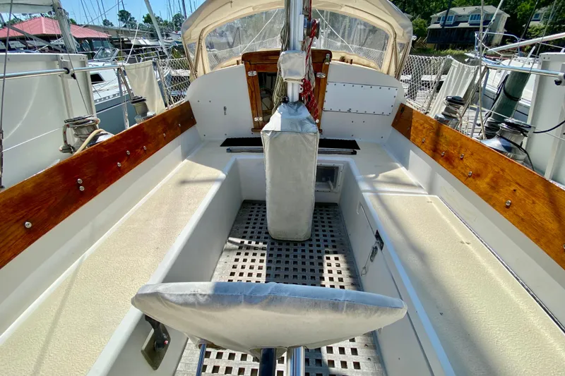 Slide: The Image of 1977 Allied Princess Cutter sailboat cockpit with wooden accents and seating. - 8