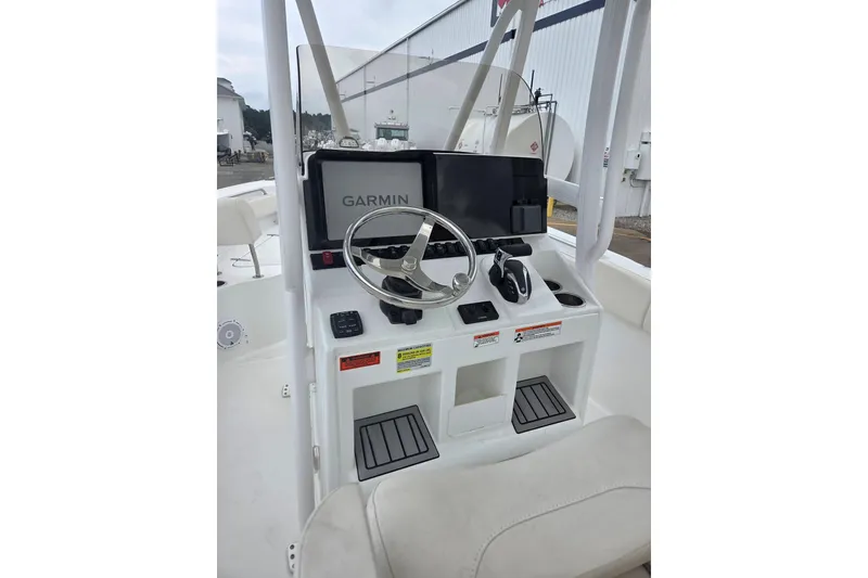 Slide: The Image of 2023 Sea Hunt Ultra 234 boat console with Garmin navigation system and steering wheel. - 24