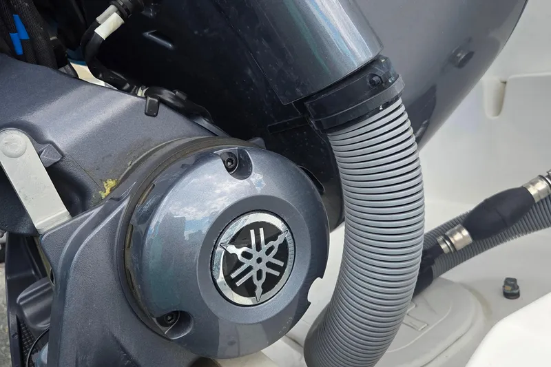 Slide: The Image of Close-up of a 2023 Sea Hunt Ultra 234 boat engine component with tubing. - 29
