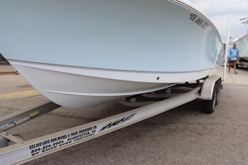 Slide: The Image of 2023 Sea Hunt Ultra 234 boat on trailer, displayed outdoors. - 3