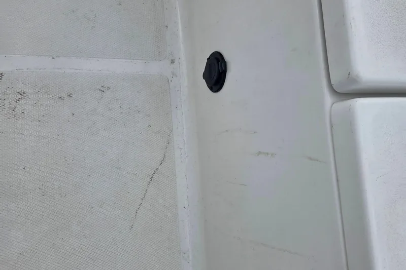 Slide: The Image of 2023 Sea Hunt Ultra 234 boat deck with textured surface and black fitting. - 32