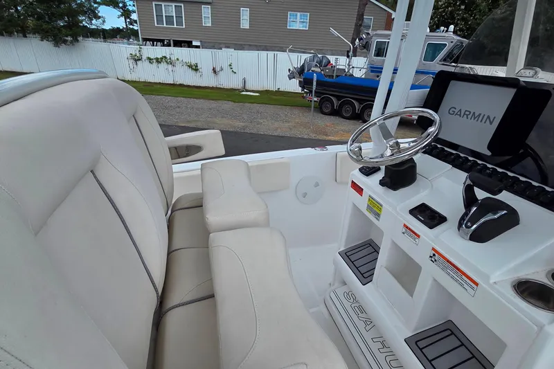 Slide: The Image of 2023 Sea Hunt Ultra 234 boat interior with Garmin navigation system and comfortable seating. - 34