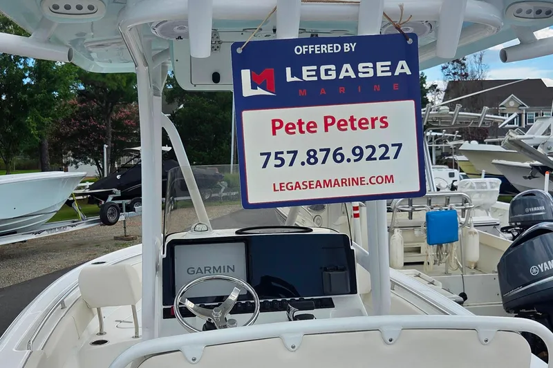 Slide: The Image of 2023 Sea Hunt Ultra 234 boat with Legasea Marine sign, Garmin navigation, and Yamaha engines. - 35
