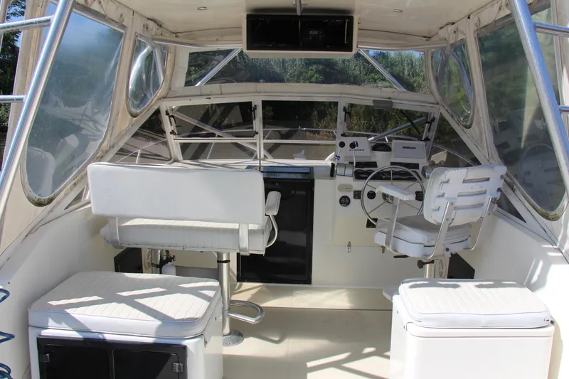 Slide: The Image of Interior of a 2004 Carolina Classic 28 boat with helm and seating area. - 12