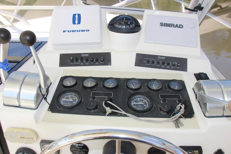 Slide: The Image of Control panel of a 2004 Carolina Classic 28 boat with navigation instruments. - 15
