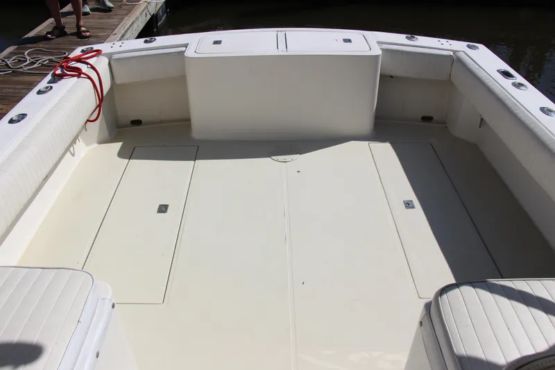 Slide: The Image of 2004 Carolina Classic 28 boat deck with seating and storage compartments. - 19