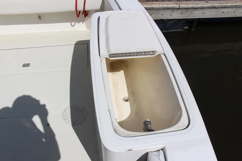 Slide: The Image of Open storage compartment on a 2004 Carolina Classic 28 boat deck. - 20