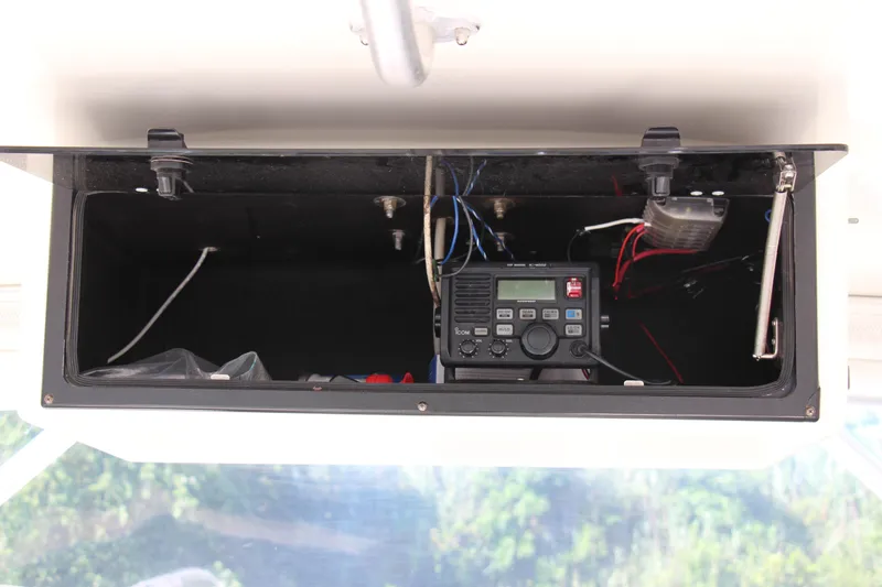Slide: The Image of 2004 Carolina Classic 28 boat radio compartment with electronic equipment and wiring. - 21