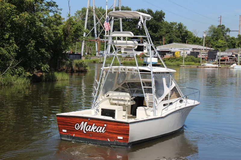 Slide: The Image of 2004 Carolina Classic 28 boat named Makai on a calm river. - 27