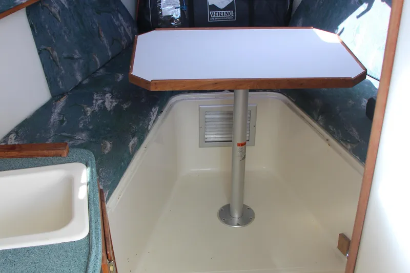 Slide: The Image of 2004 Carolina Classic 28 cabin interior with table and seating area. - 4