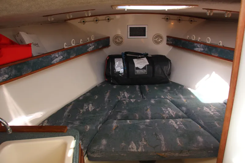 Slide: The Image of 2004 Carolina Classic 28 cabin interior with patterned cushions and storage compartments. - 8