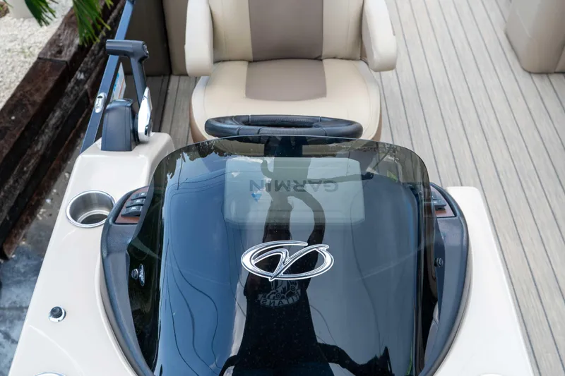 Slide: The Image of 2022 Veranda Relax VR25RC boat dashboard with steering wheel and seating. - 15