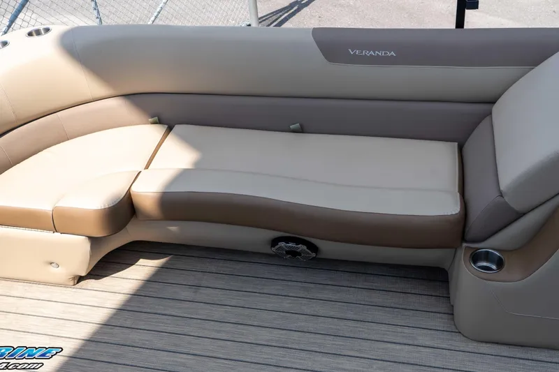 Slide: The Image of 2022 Veranda Relax VR25RC boat interior with beige seating and cup holder. - 17