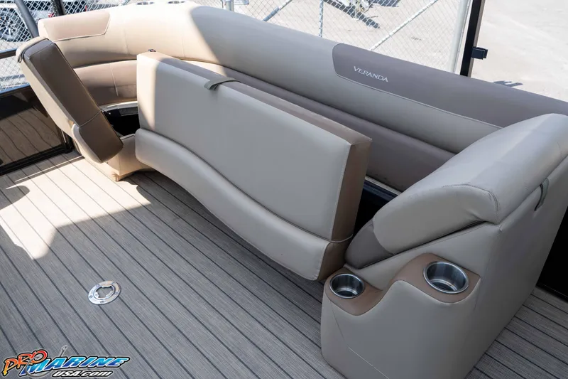 Slide: The Image of 2022 Veranda Relax VR25RC boat interior with beige seating and cup holders. - 18
