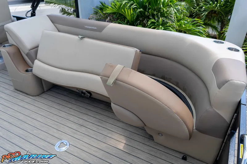 Slide: The Image of 2022 Veranda Relax VR25RC boat seating with beige upholstery and cup holders. - 20