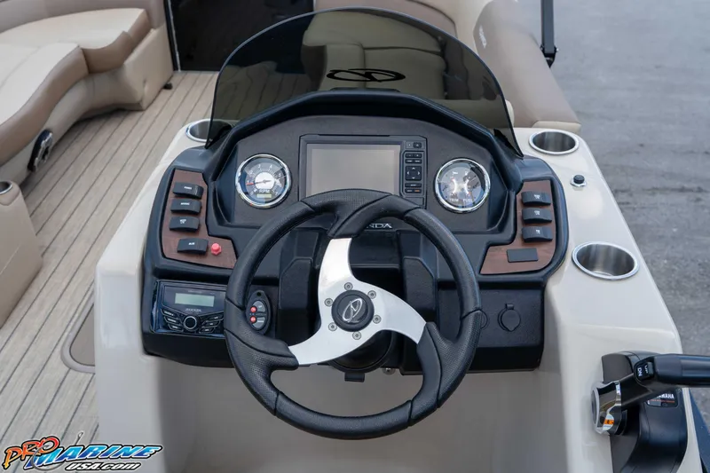 Slide: The Image of 2022 Veranda Relax VR25RC boat dashboard with steering wheel and control panel. - 22