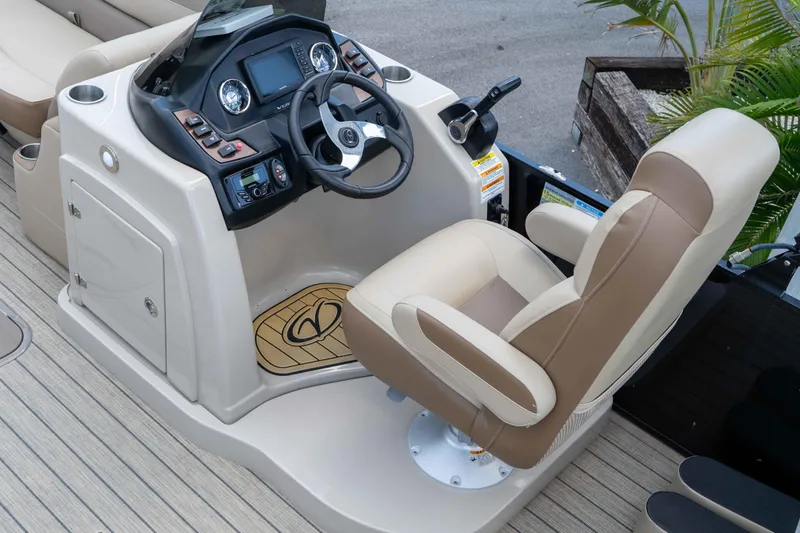 Slide: The Image of 2022 Veranda Relax VR25RC boat helm with beige captain's chair and control panel. - 32