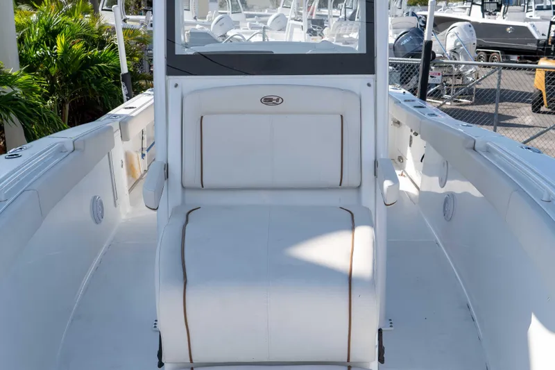 Slide: The Image of 2022 Sea Hunt Gamefish 27 Coffin Box boat interior with white seating and console. - 14