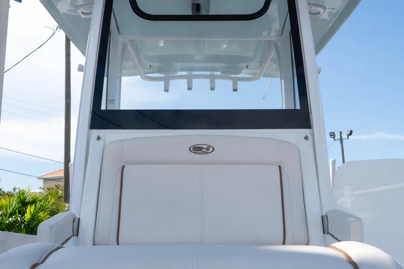 Slide: The Image of 2022 Sea Hunt Gamefish 27 Coffin Box boat, featuring sleek white seating and console. - 15