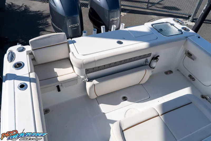 Slide: The Image of 2022 Sea Hunt Gamefish 27 Coffin Box boat interior with seating and dual engines. - 19