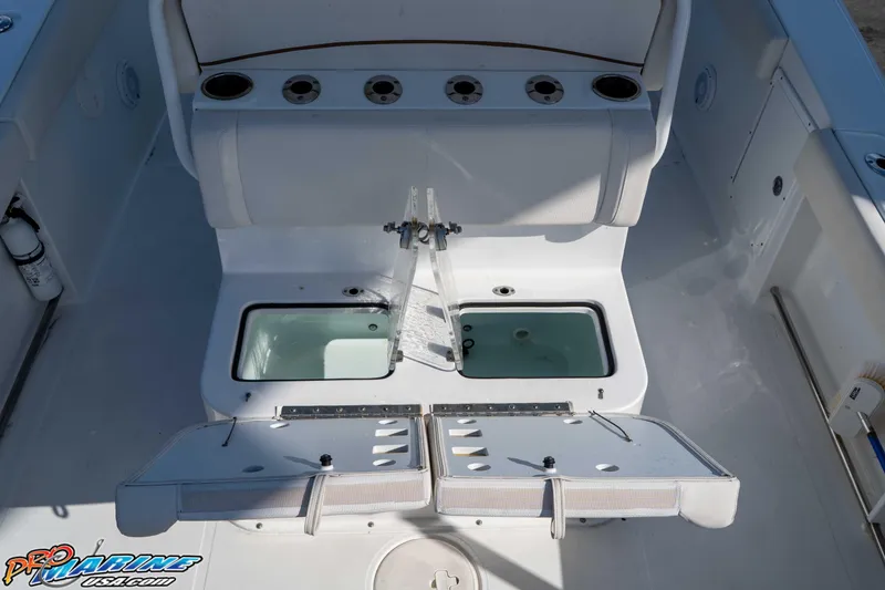 Slide: The Image of 2022 Sea Hunt Gamefish 27 Coffin Box interior with storage compartments and seating. - 23