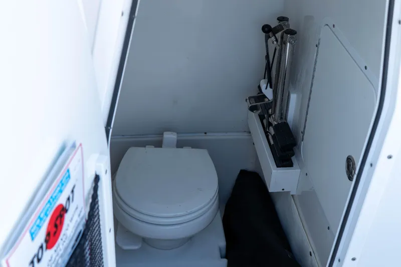 Slide: The Image of 2022 Sea Hunt Gamefish 27 Coffin Box boat interior with toilet and storage area. - 24