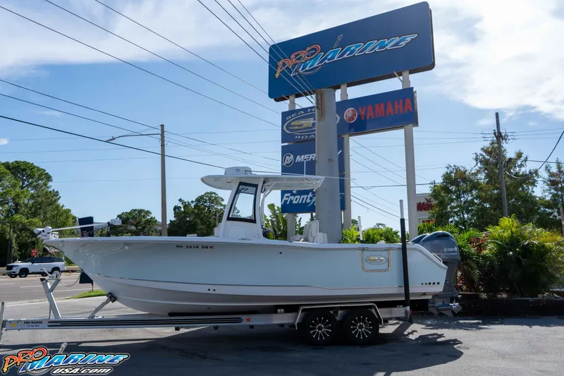 Slide: The Image of 2022 Sea Hunt Gamefish 27 Coffin Box boat on trailer at dealership. - 4
