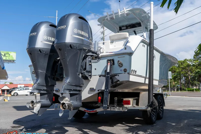 Slide: The Image of 2022 Sea Hunt Gamefish 27 Coffin Box boat with dual Yamaha 200 engines on trailer. - 7