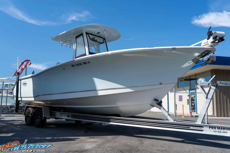 Slide: The Image of 2022 Sea Hunt Gamefish 27 Coffin Box boat on trailer under clear blue sky. - 9