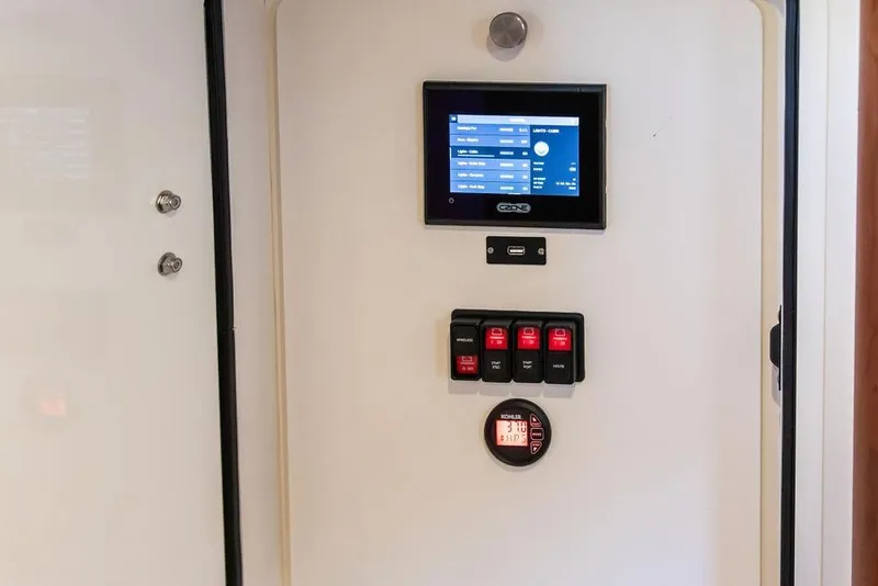 Slide: The Image of Control panel of 2023 Hinckley Picnic Boat 34 S with touchscreen and switches. - 26