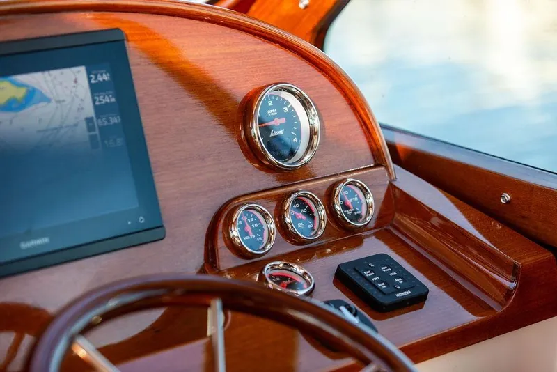 Slide: The Image of 2023 Hinckley Picnic Boat 34 S dashboard with gauges and navigation screen. - 16