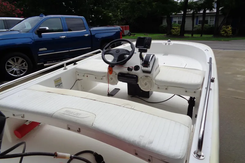 Slide: The Image of 2005 Boston Whaler 110 Sport boat interior with steering wheel and seating. - 6