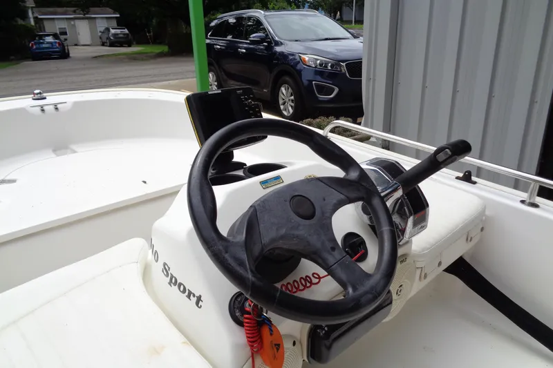 Slide: The Image of 2005 Boston Whaler 110 Sport boat interior with steering wheel and controls. - 8