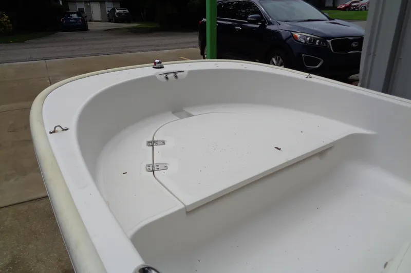 Slide: The Image of 2005 Boston Whaler 110 Sport boat interior, parked on driveway near a car. - 9