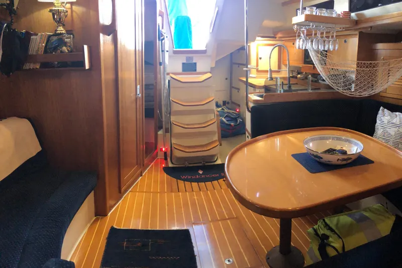 Slide: The Image of Interior of a 2002 Catalina 42 MkII sailboat with cozy seating and dining area. - 12