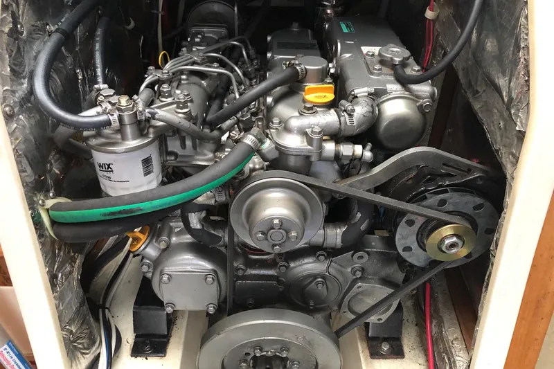 Slide: The Image of Engine compartment of a 2002 Catalina 42 MkII sailboat, showcasing mechanical components and belts. - 13