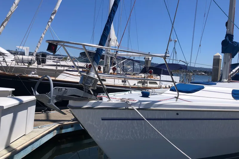 Slide: The Image of 2002 Catalina 42 MkII sailboat docked at marina under clear blue sky. - 14