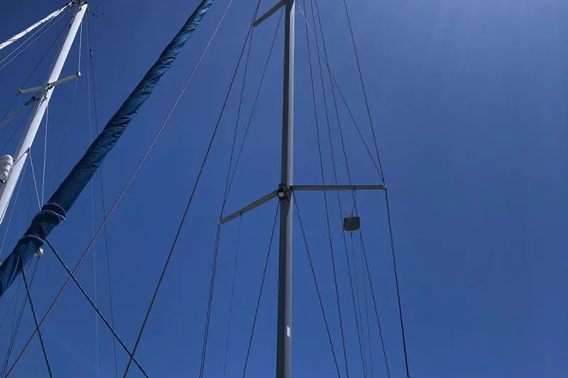 Slide: The Image of Mast and rigging of a 2002 Catalina 42 MkII sailboat against a clear blue sky. - 19