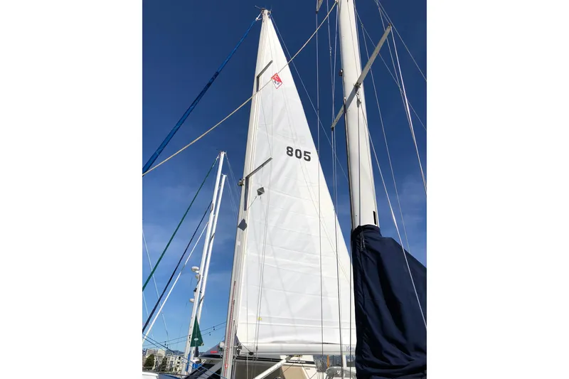 Slide: The Image of Sailboat mast and sail of a 2002 Catalina 42 MkII against a clear blue sky. - 22