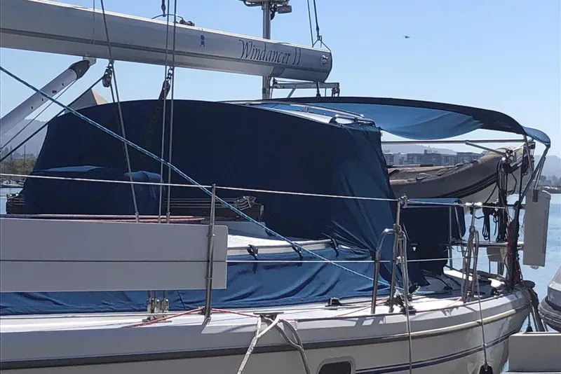 Slide: The Image of 2002 Catalina 42 MkII sailboat docked with blue covers and visible rigging. - 26