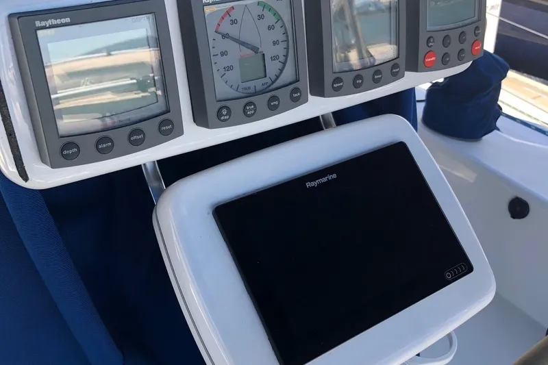 Slide: The Image of Cockpit instruments on a 2002 Catalina 42 MkII sailboat, featuring Raytheon and Raymarine displays. - 29