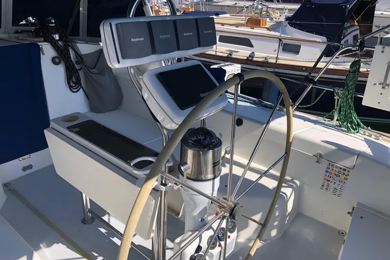 Slide: The Image of Cockpit of a 2002 Catalina 42 MkII sailboat with navigation equipment and steering wheel. - 34