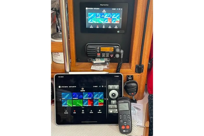 Slide: The Image of Navigation equipment on a 2002 Catalina 42 MkII sailboat, featuring Raymarine displays and controls. - 5