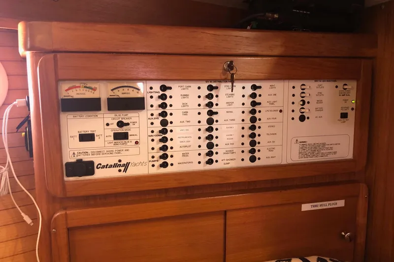 Slide: The Image of Control panel of a 2002 Catalina 42 MkII yacht, featuring various switches and gauges. - 6