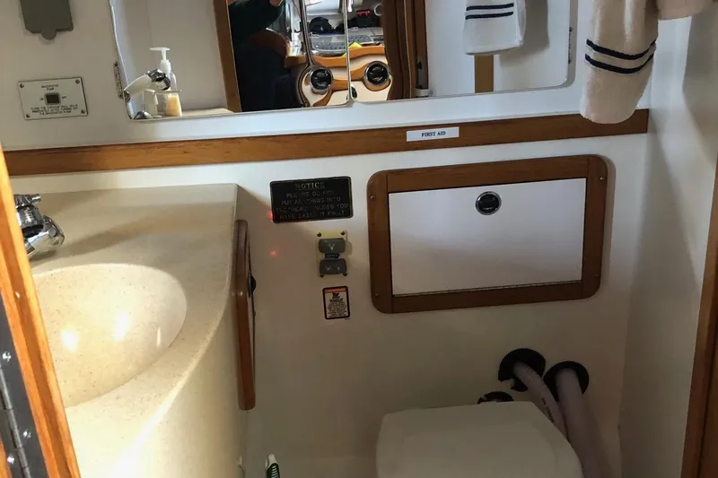 Slide: The Image of Bathroom interior of a 2002 Catalina 42 MkII sailboat with sink and storage. - 8