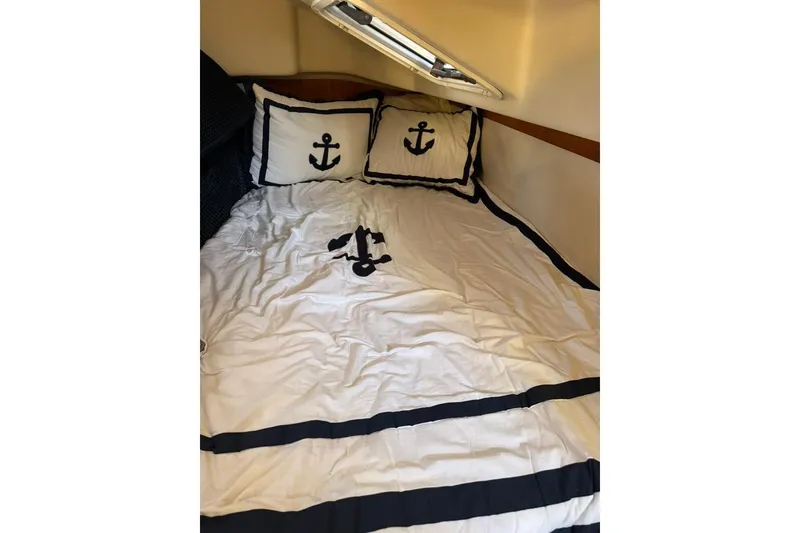 Slide: The Image of Nautical-themed bedding in a 2002 Catalina 42 MkII cabin, featuring anchor designs. - 9